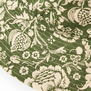 Detail of a bucket hat featuring a green floral pattern.